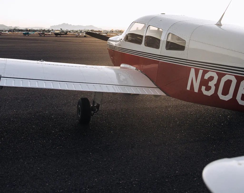 A Venture West Piper on the ramp at Falcon Field, with its wing and the Arizona mountains in view
