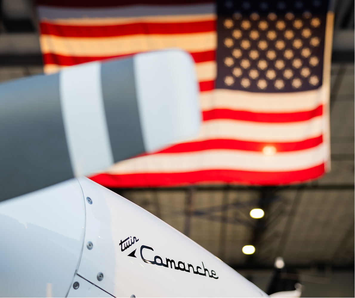 Twin Comanche aircraft tail with American flag at Venture West Aviation